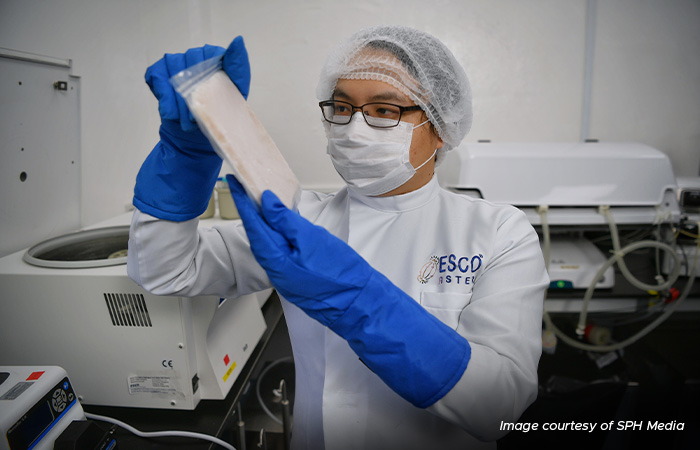 Esco Aster Chief Executive Lin Xiangliang with a packet of cell-cultured meat at his firm’s lab in 2021.