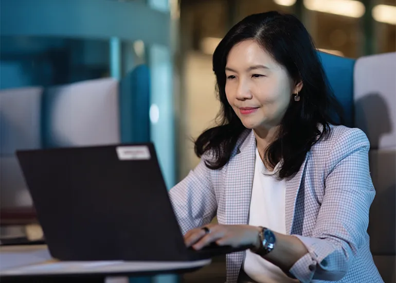 Rowena Yeo typing on her laptop