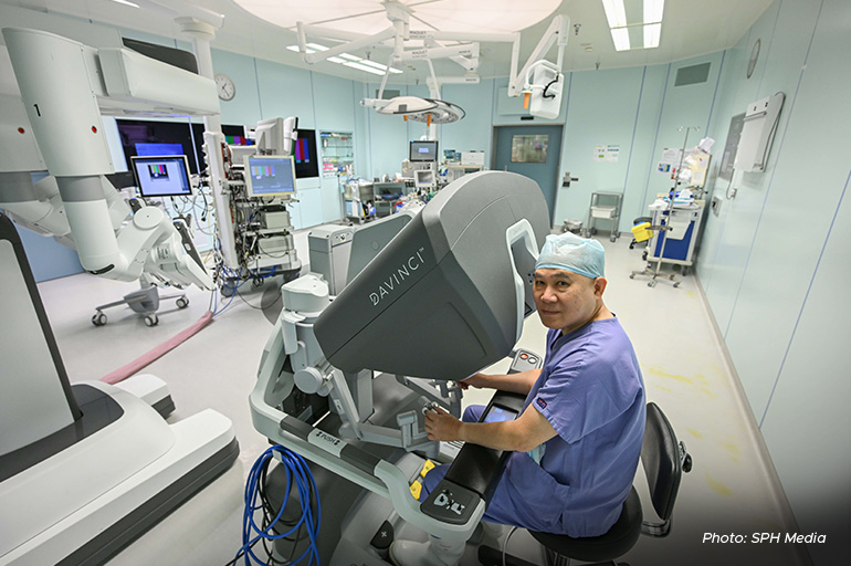 Mount Elizabeth Novena Hospital Urologist Chin Chong Min with a Da Vinci surgical robotic assistant.