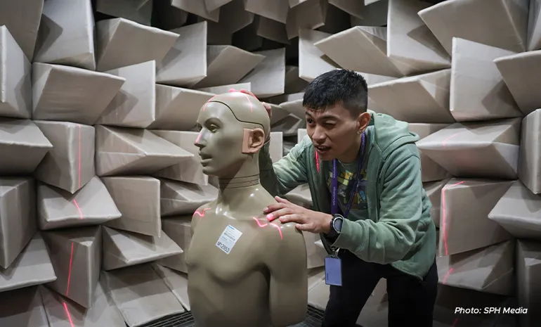 Acoustics engineer Trevor Wong is aligning the hearing aid to the centre of the room to ensure the sound measurement is accurate at the Anechoic chamber in WS Audiology Singapore’s office.