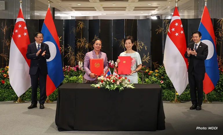 Laos’ Minister of Natural Resources and Environment Bounkham Vorachit (second from left) inking the memorandum of understanding related to carbon credits collaboration with Minister for Sustainability and the Environment Grace Fu (second from right) on 9 July.