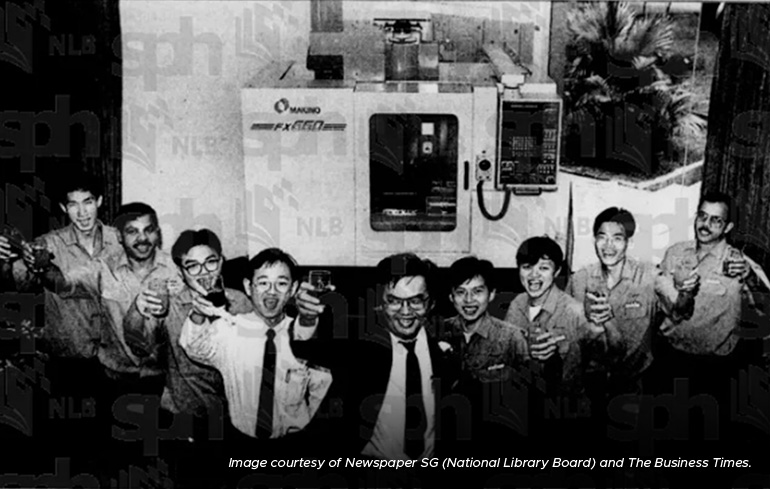 Above: An engineering team of nine men, led by Chao Tian Kong (centre), toasting to the launch of Makino Asia’s FX 650 system, which was designed, developed, and produced in Singapore in 1992. The streamlined vertical machining centre is designed for precision manufacturing. Photo: Newspaper SG (National Library Board) and The Business Times