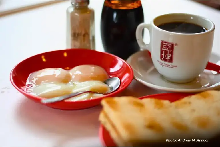 Enjoy breakfast like a local – freshly brewed kopi with kaya toast and soft-boiled eggs.