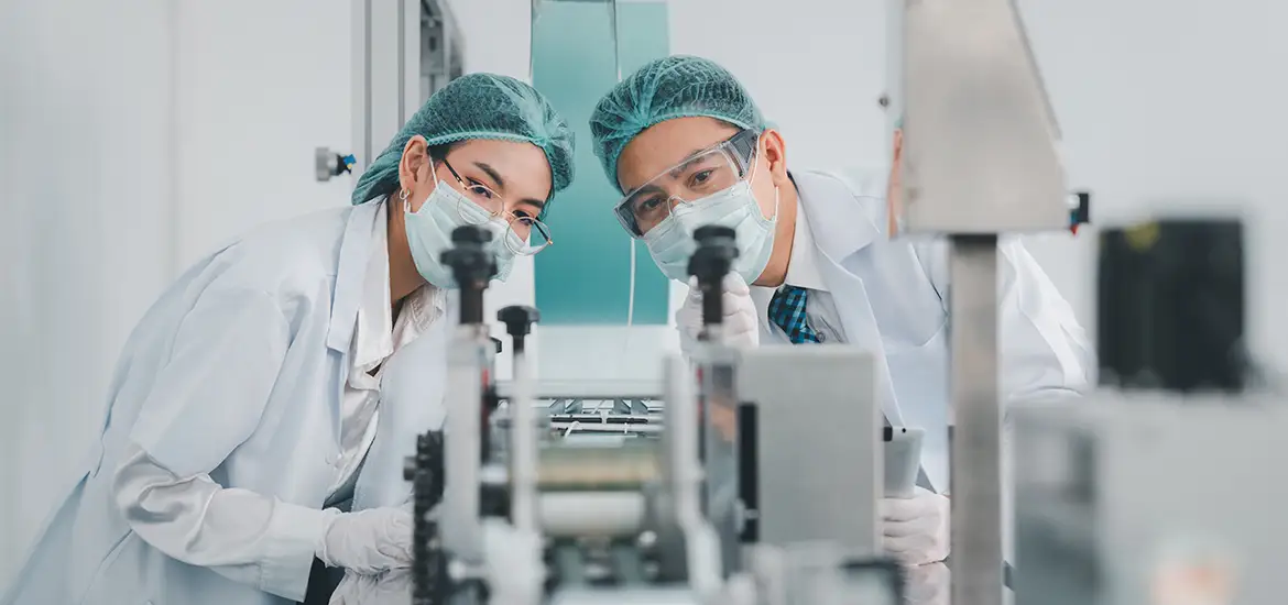 Two scientist inspecting a machine