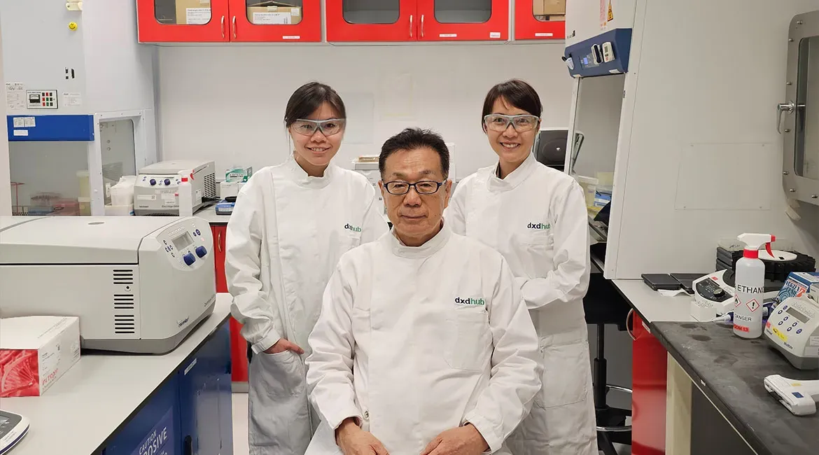 Dr Masafumi Inoue (centre), Senior Principal Scientist at the Diagnostics Development (DxD) Hub, flanked by Ms Karen Lee (left) and Ms Goh Mei Ling (right). The trio worked on the “Fortitude”, a novel coronavirus diagnostic test kit.